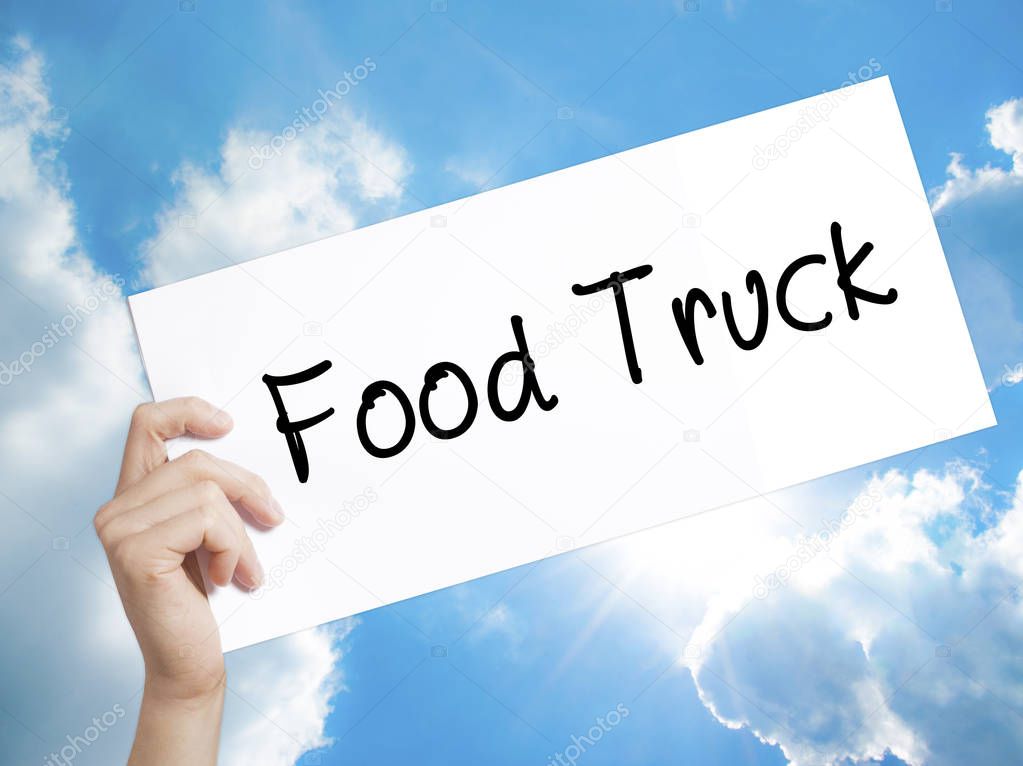 Food Truck Sign on white paper. Man Hand Holding Paper with text