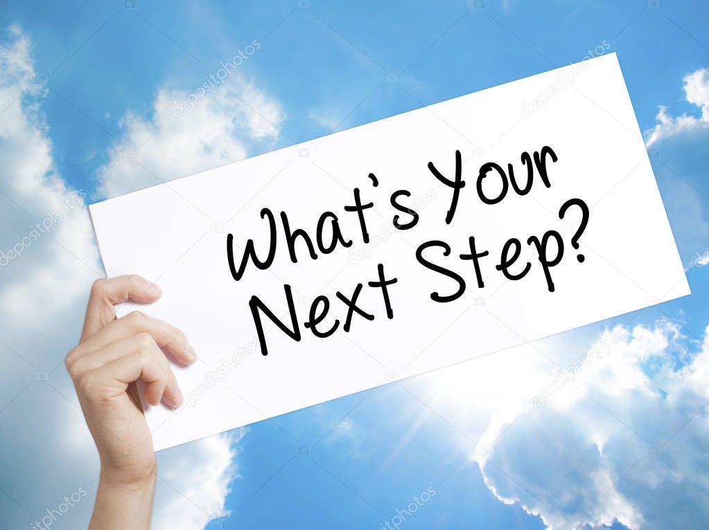 What's Your Next Step? Sign on white paper. Man Hand Holding Pap