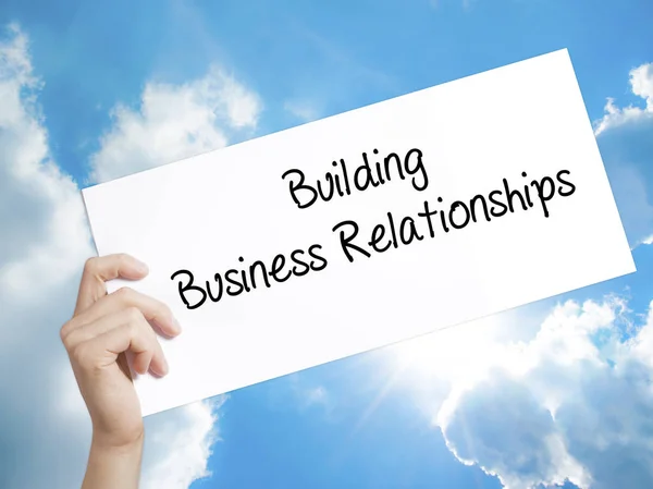 Building Business Relationships  Sign on white paper. Man Hand