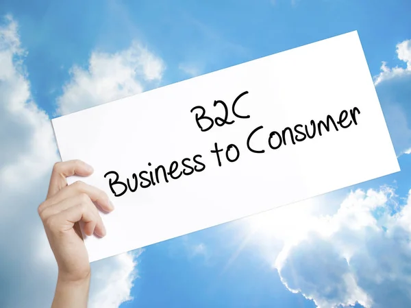 B2C Business to Consumer Sign on white paper. Man Hand Holding P