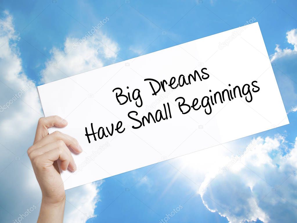Big Dreams Have Small Beginnings Sign on white paper. Man Hand H