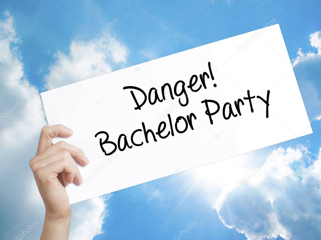 Danger! Bachelor Party Sign on white paper. Man Hand Holding Pap