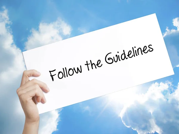 Follow the Guidelines  Sign on white paper. Man Hand Holding Pap — Stock Photo, Image