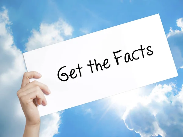 Get the Facts  Sign on white paper. Man Hand Holding Paper with