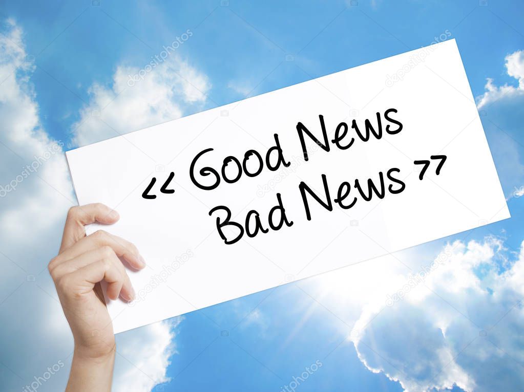 Good News - Bad News Sign on white paper. Man Hand Holding Paper