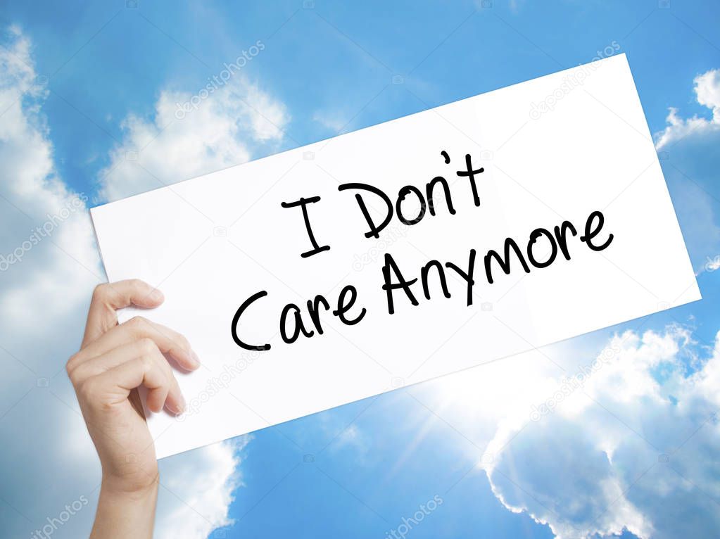 I Don't Care Anymore Sign on white paper. Man Hand Holding Paper