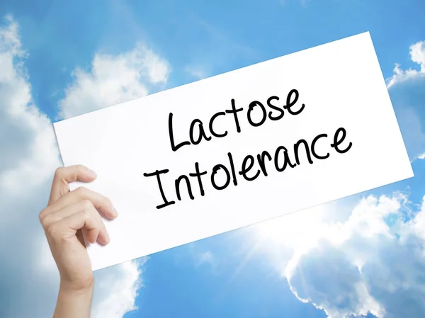 Lactose Intolerance Sign on white paper. Man Hand Holding Paper