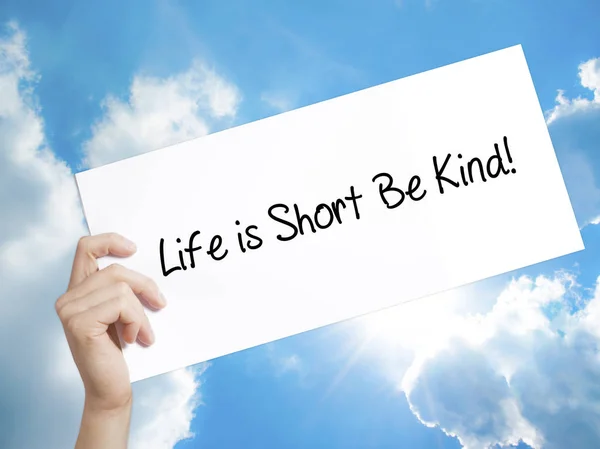 Life is Short Be Kind! Sign on white paper. Man Hand Holding Pap