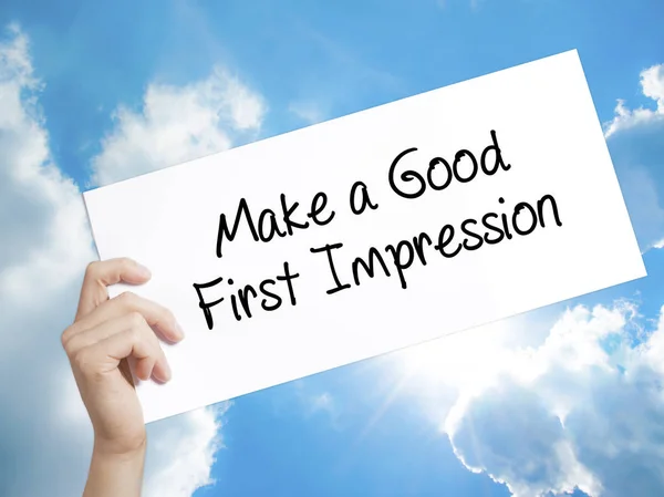 Make a Good First Impression Sign on white paper. Man Hand Holdi