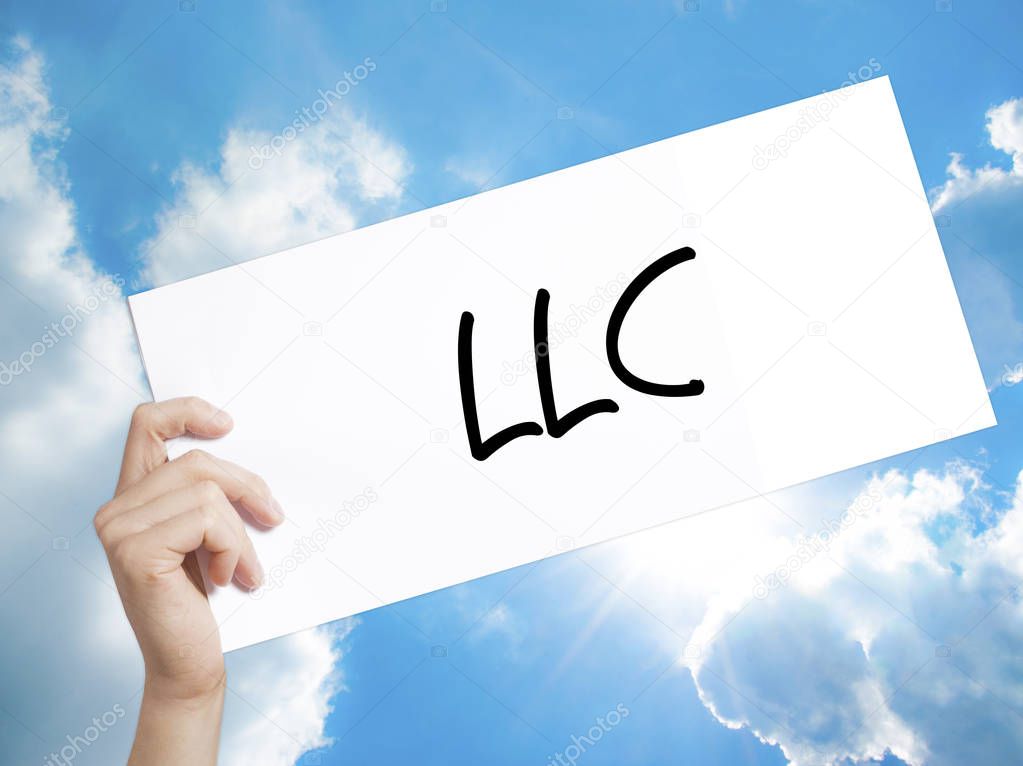  LLC (Limited Liability Company)  Sign on white paper. Man Hand 