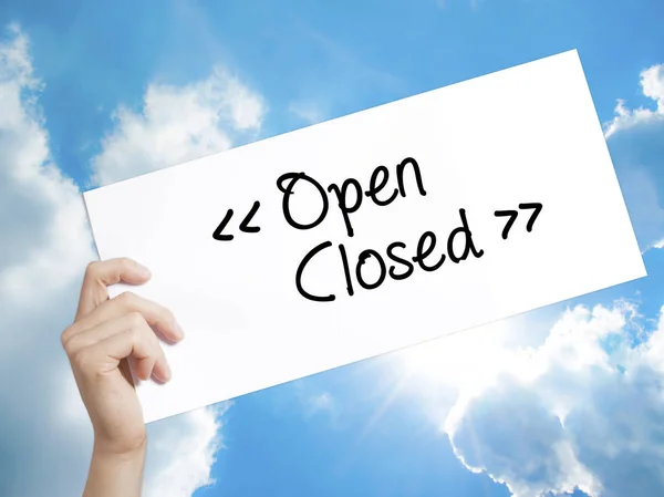 Open - Closed Sign on white paper. Man Hand Holding Paper with t — Stock Photo, Image