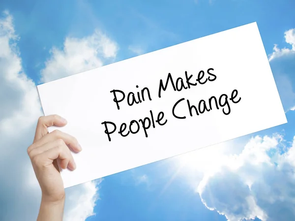 Pain Makes People Change  Sign on white paper. Man Hand Holding