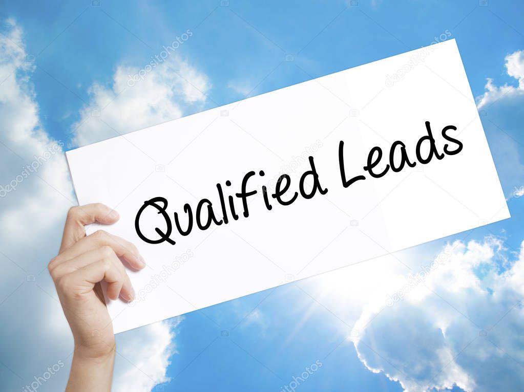 Qualified Leads Sign on white paper. Man Hand Holding Paper with