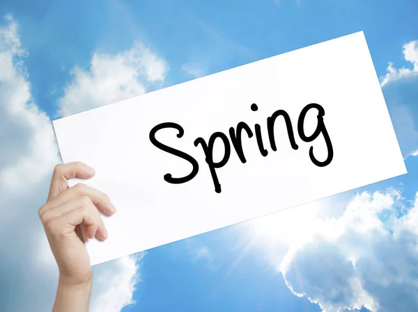 Spring Sign on white paper. Man Hand Holding Paper with text. Is — Stock Photo, Image