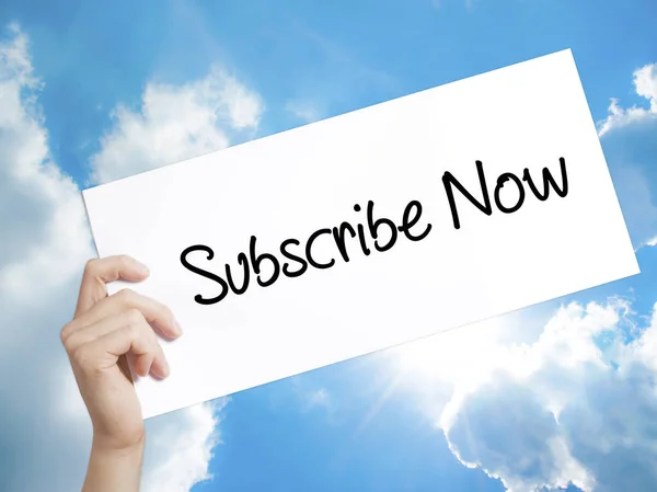 Subscribe Now Sign on white paper. Man Hand Holding Paper with t