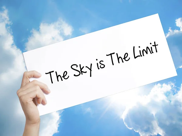 The Sky is The Limit  Sign on white paper. Man Hand Holding Pape