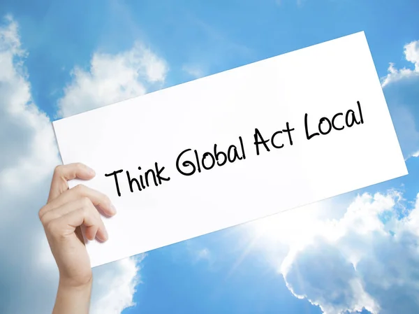 Think Global Act Local Sign on white paper. Man Hand Holding Pap