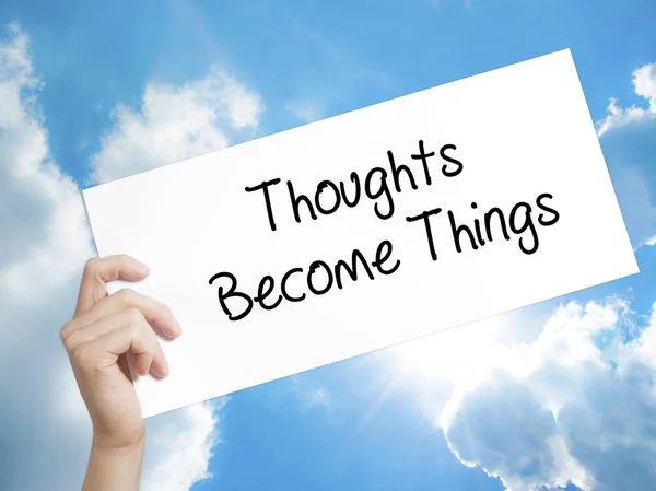 Thoughts Become Things Sign on white paper. Man Hand Holding Pap — Stock Photo, Image