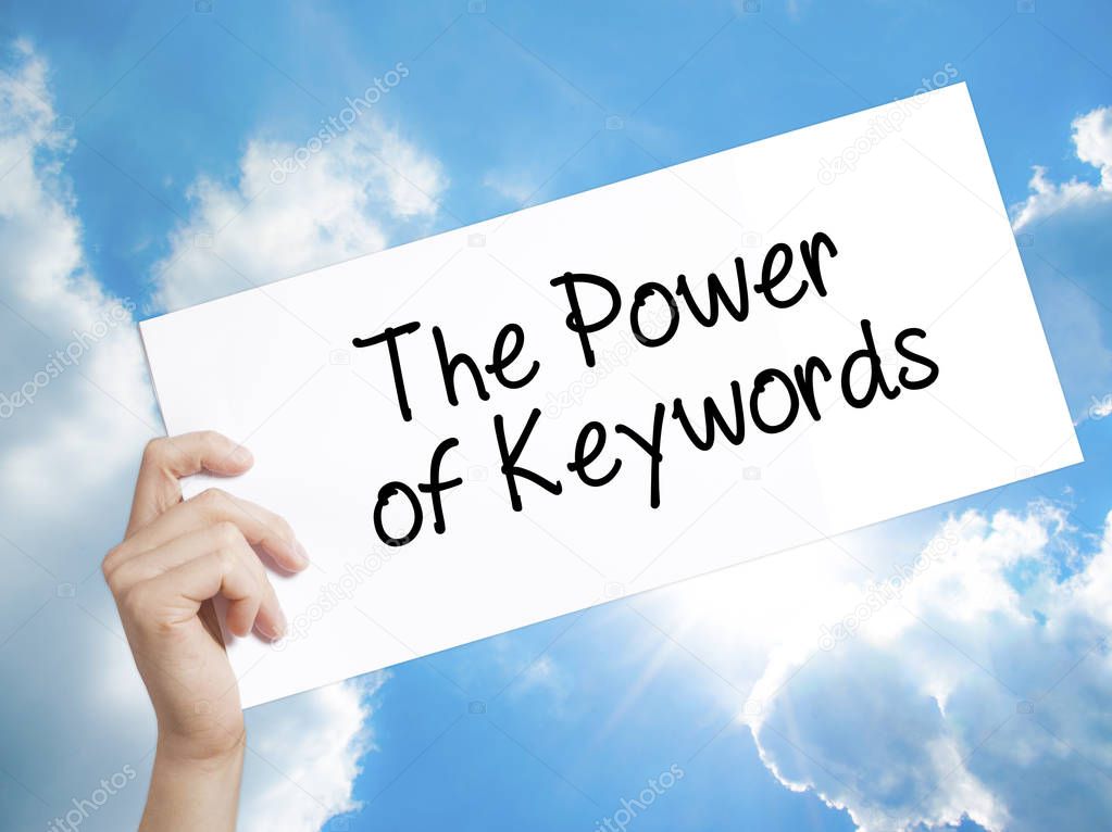 The Power of Keywords Sign on white paper. Man Hand Holding Pape