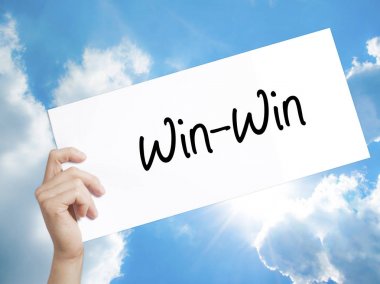 Win-Win  Sign on white paper. Man Hand Holding Paper with text.  clipart