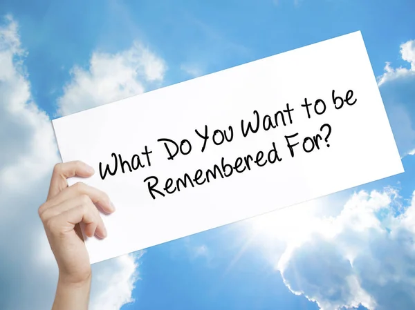 What Do You Want to be Remembered For? Sign on white paper. Man