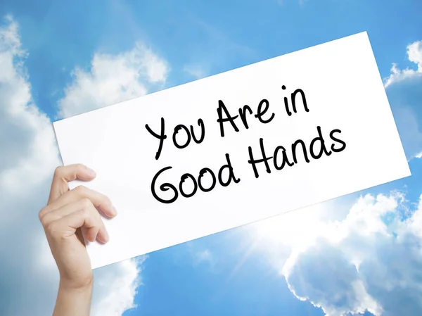 You Are in Good Hands Sign on white paper. Man Hand Holding Pape