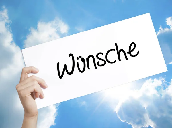 Знак Wunsche (побажання німецькою мовою) на білому папері. Людина сторони-Холдинг — стокове фото