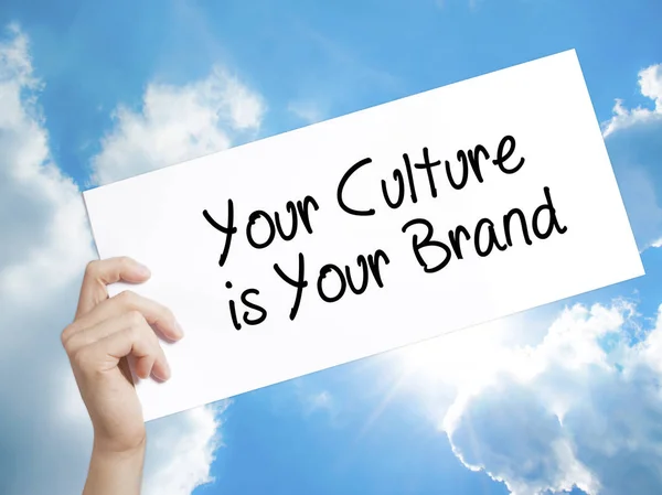 Your Culture is Your Brand Sign on white paper. Man Hand Holding