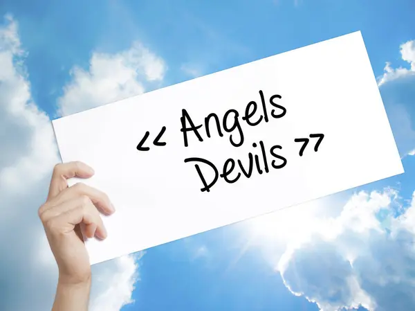 Angels - Devils Sign on white paper. Man Hand Holding Paper with