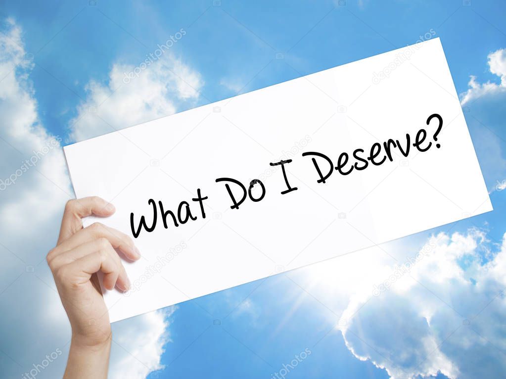 What Do I Deserve? Sign on white paper. Man Hand Holding Paper w