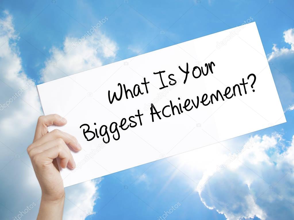What Is Your Biggest Achievement? Sign on white paper. Man Hand 