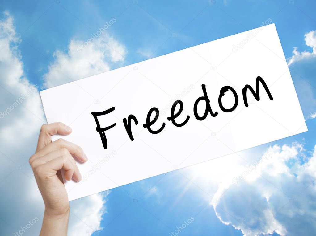 Freedom Sign on white paper. Man Hand Holding Paper with text. I