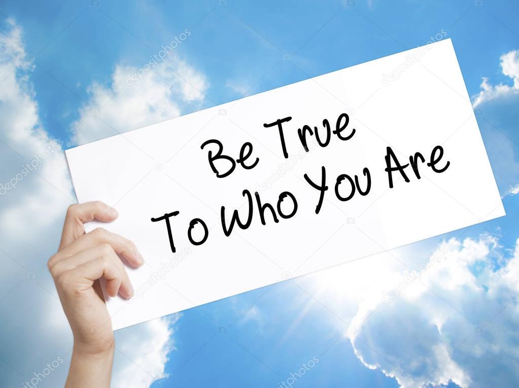 Be True To Who You Are Sign on white paper. Man Hand Holding Pap