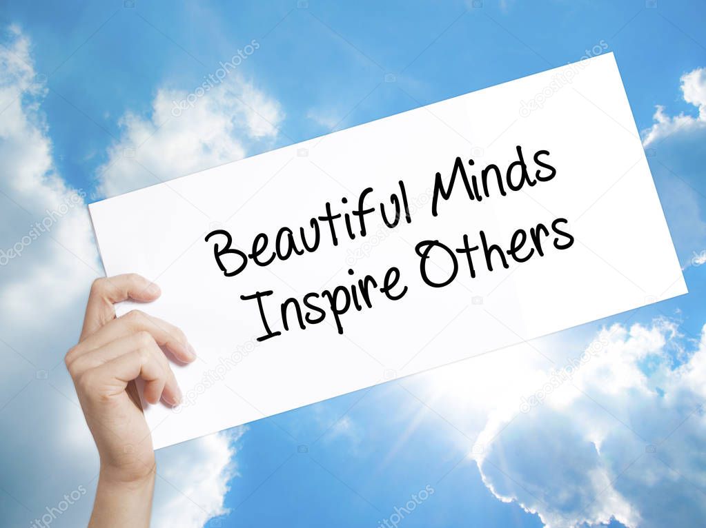 Beautiful Minds Inspire Others Sign on white paper. Man Hand Hol