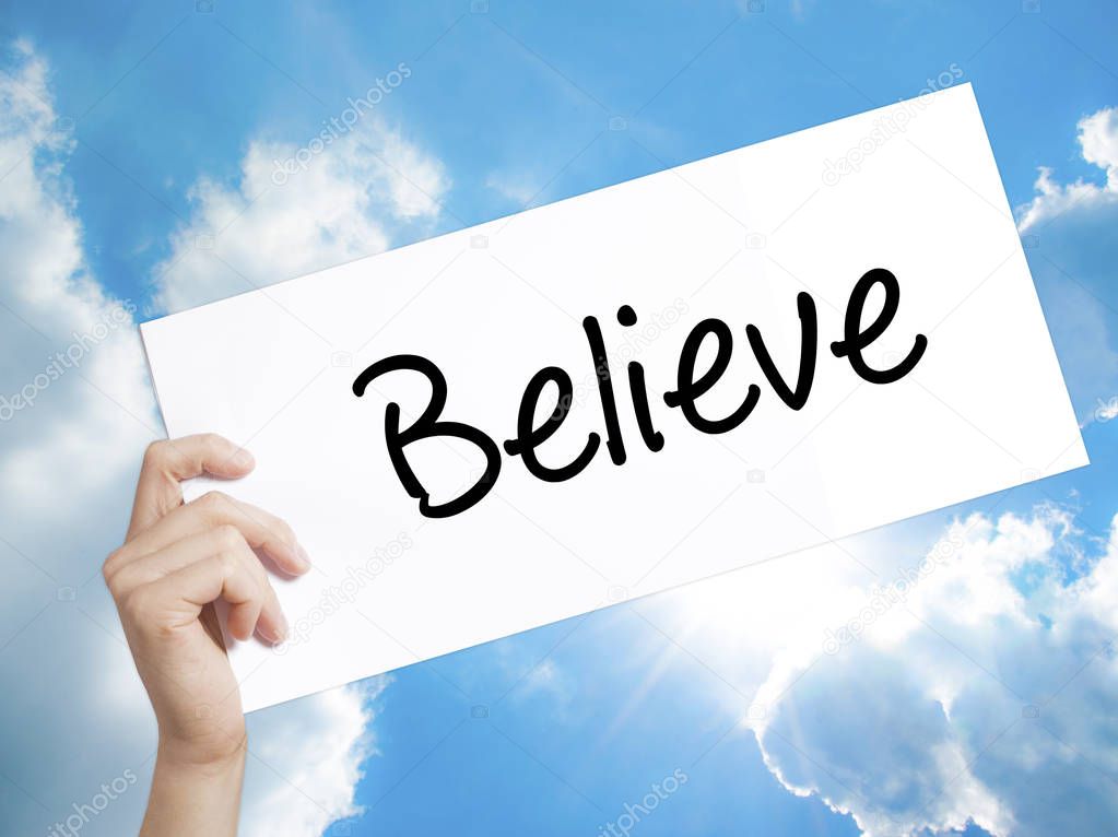 Believe Sign on white paper. Man Hand Holding Paper with text. I