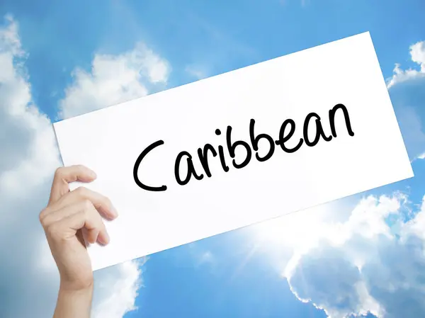 Karaiby znak na białym papierze. Człowiek ręka gospodarstwa papieru z tekstem. — Zdjęcie stockowe