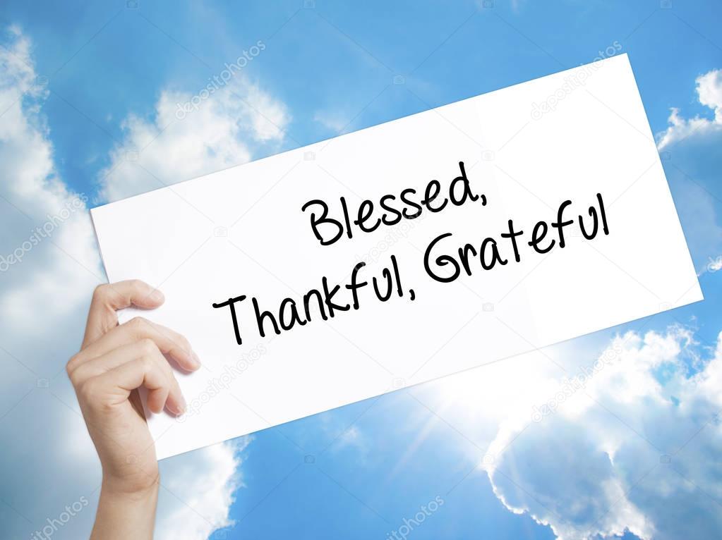  Blessed Thankful Grateful Sign on white paper. Man Hand Holding