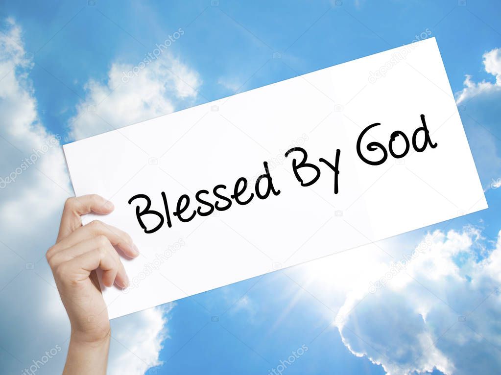 Blessed By God Sign on white paper. Man Hand Holding Paper with 