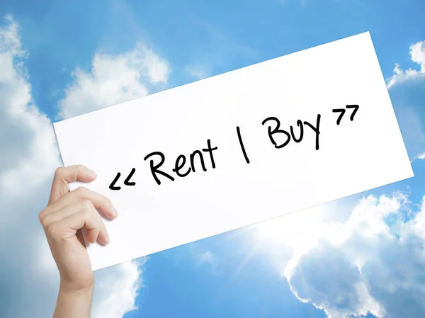 Rent - Buy  Sign on white paper. Man Hand Holding Paper with tex