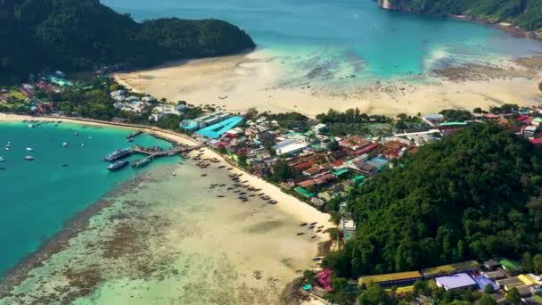 Antenn häpnadsväckande skott av tropisk ö hamnen på en uppfriskande lugn morgon. Förtöjda båtar och färjor vänta för folkmassorna av turister att ta dem Båtluffa runt de spektakulära Phi Phi-öarna — Stockvideo