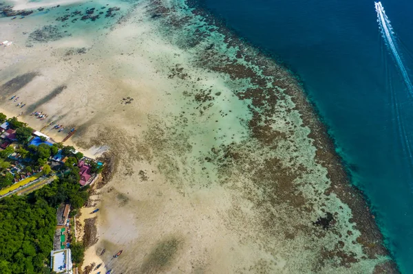 Flying over a busy paradise island harbor on a beautiful summer