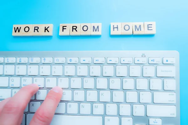 concept work from home \'Work From Home\' written post it on laptop keyboard