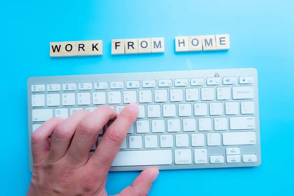 concept work from home \'Work From Home\' written post it on laptop keyboard