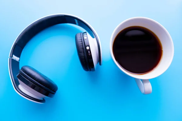 Headphones Coffee Cup Blue Background Table Music Concept Top View — Stock Photo, Image