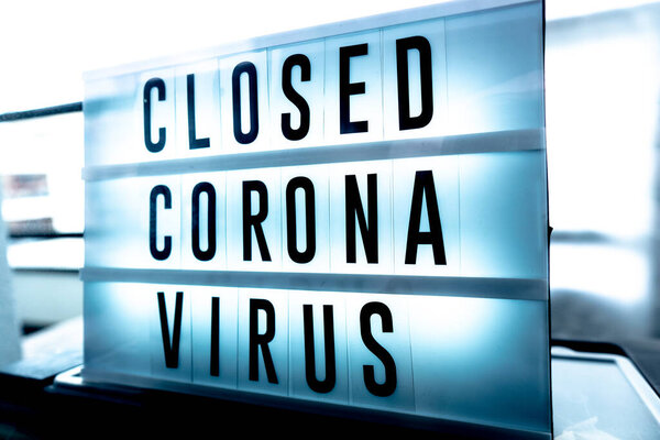 Closed businesses for CoronaVirus pandemic outbreak, closure sign on retail store window banner background. Government shutdown of restaurants, shopping stores, non essential services.