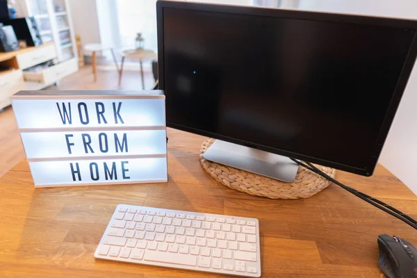 Working from home remote work inspirational social media lightbox message board next to monitor, COVID-19 quarantine closure of all