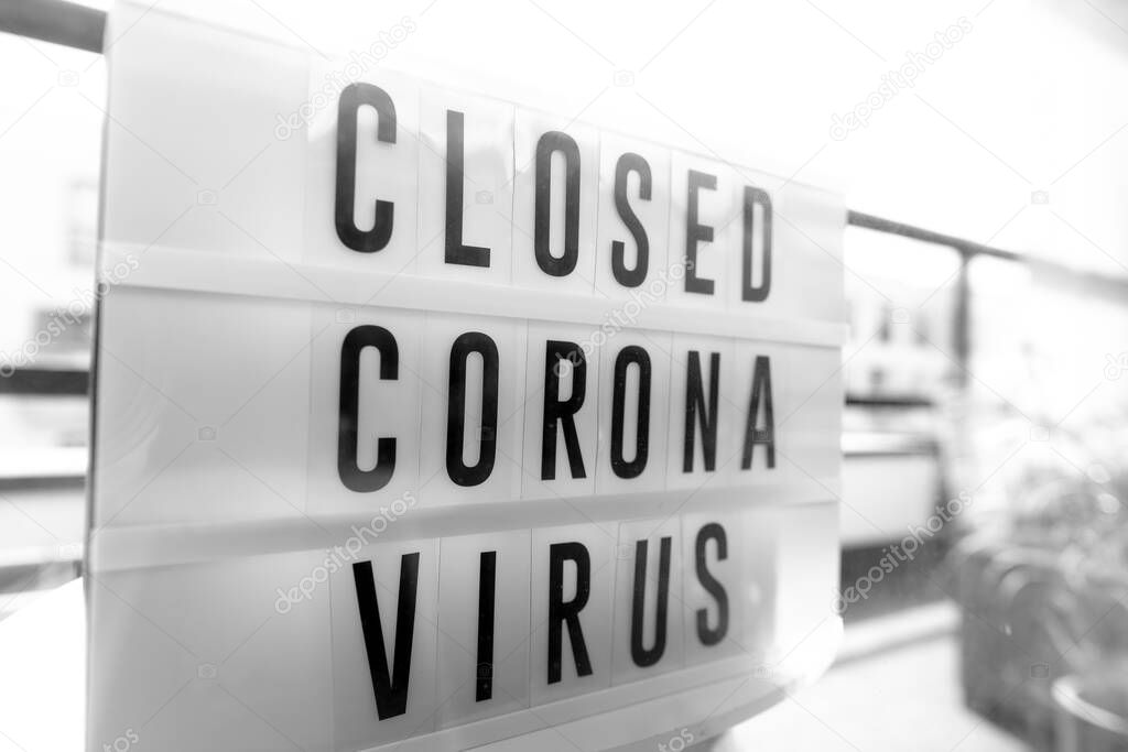 Closed businesses for CoronaVirus pandemic outbreak, closure sign on retail store window banner background. Government shutdown of restaurants, shopping stores, non essential services.
