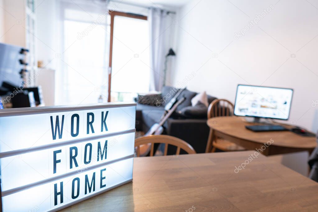 Working from home remote work inspirational social media lightbox message board next to monitor, COVID-19 quarantine closure of all