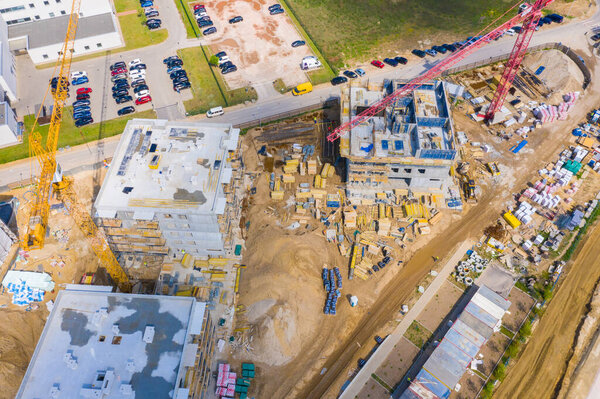 Construction of new apartment buildings in the city residential area. construction site with tower cranes. aerial view