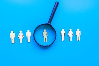 Çalışan insan kaynakları konsepti - mavi arka planda soyut çalışanı olan büyüteç. Kapat..